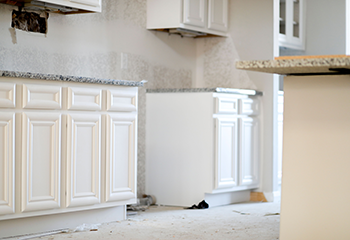 Custom white cabinet installation in Cudahy apartment kitchen with granite countertops